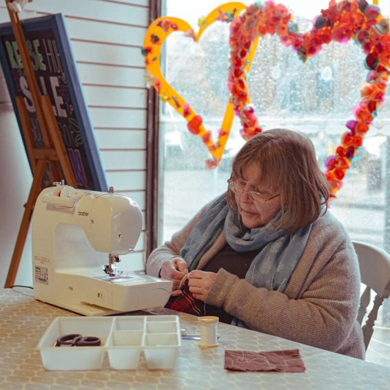 Photo of Isabella Hodge at her sewing machine